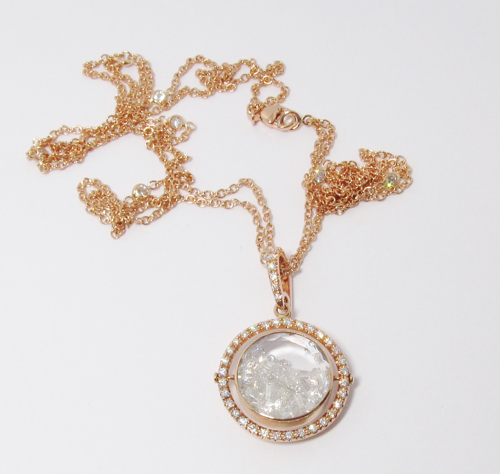 Double White Sapphire framed by a Movable Pave Halo in 18k Gold